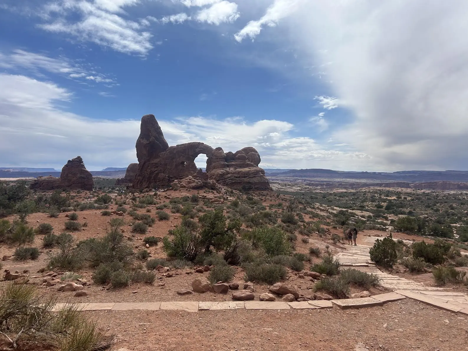 Rock formation in the distance with large hole in the middle of it