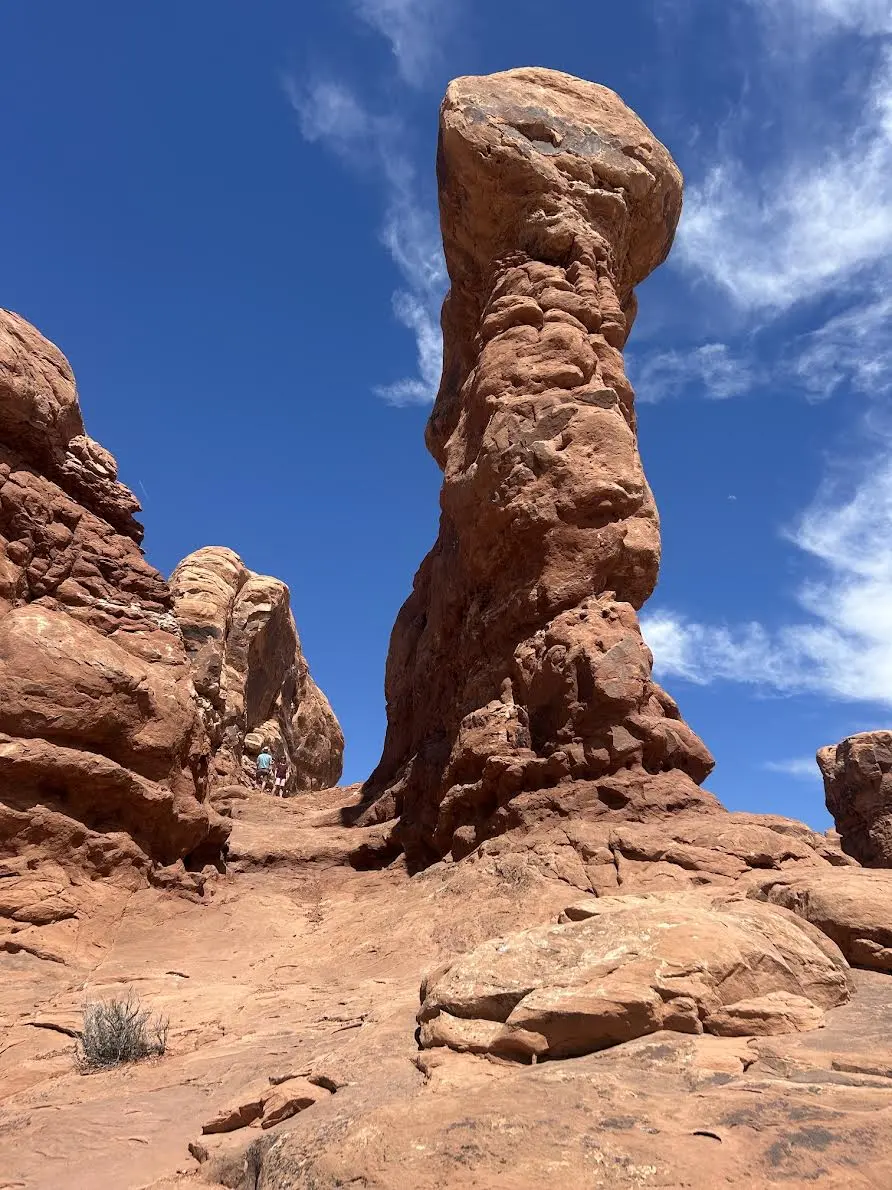 Large rock tower with boulder balanced on top of it