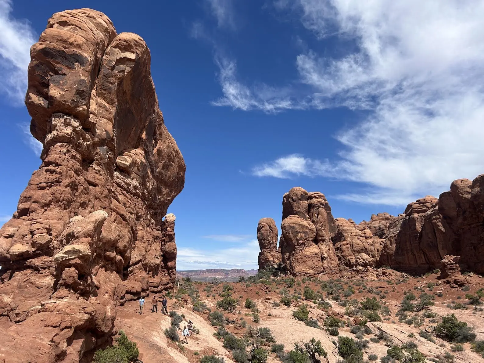 Finger like rock formations dwarfing people in the distance