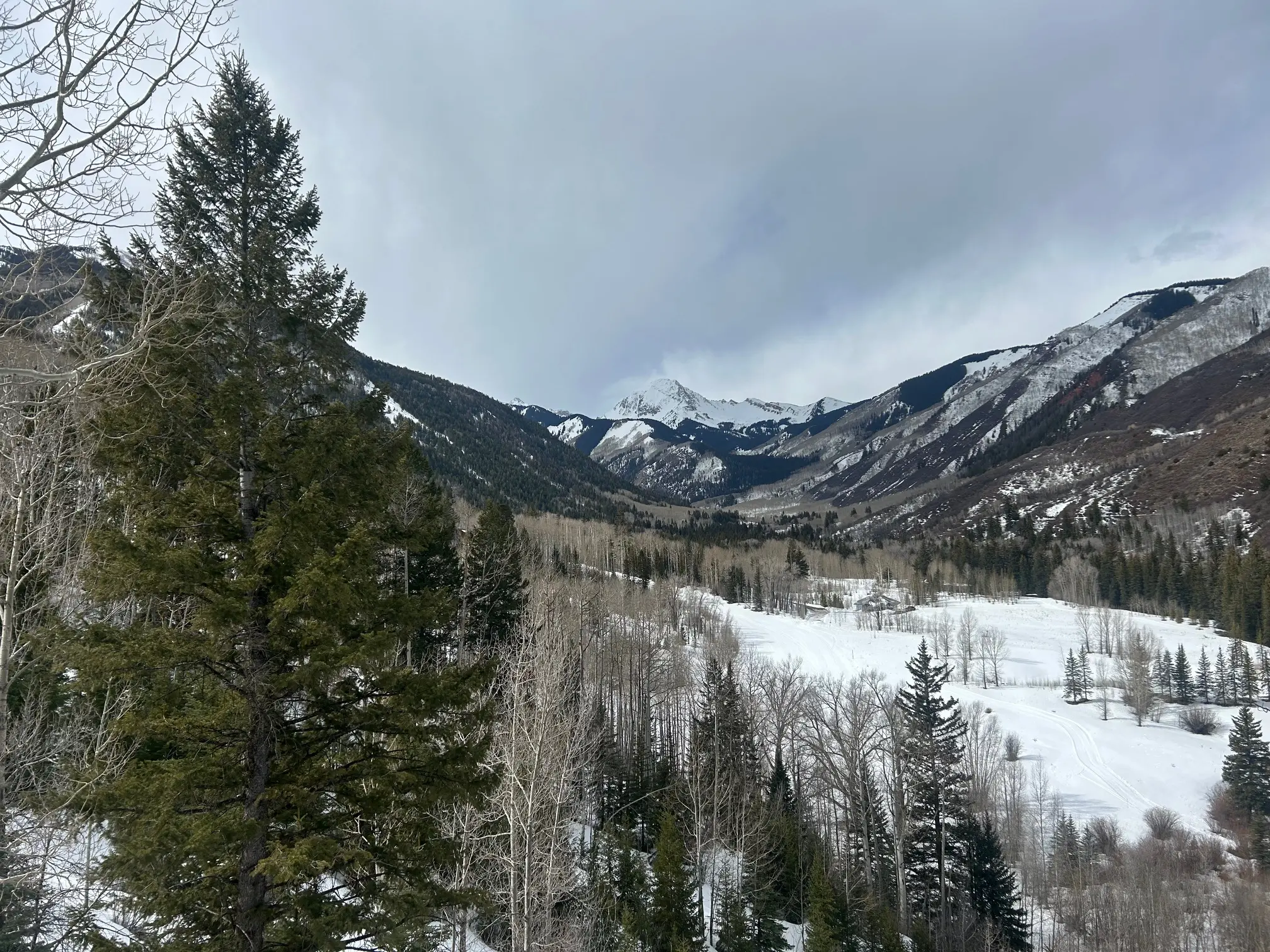 View of maroon bells valley from a chair lift on a gloomy day